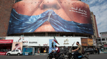 Baliho di bangunan Lapangan Valiasr, Teheran, Iran, menggambarkan wajah Presiden Amerika Serikat Donald Trump dengan Selat Hormuz, ketika difoto pada 2 Mei 2026. (AFP)

