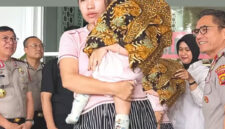 Femi (27) memeluk anak kandung perempuannya yang berusia delapan bulan di Mapolda Jambi, Rabu (29/7/2026). Sang bayi bisa kembali setelah dijual ayah kandungnya, Tedi (27). (TRIBUN JAMBI/RIFANI HALIM)